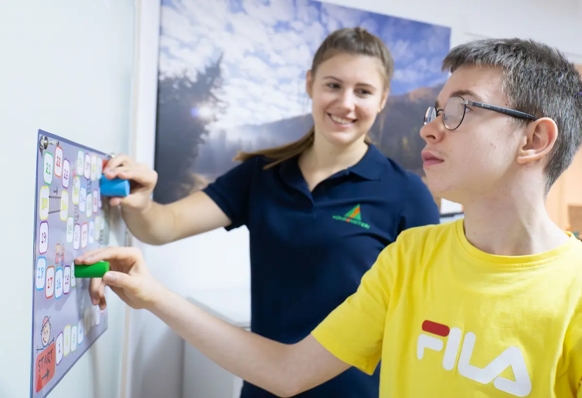An occupational therapist supporting a child with everyday skills training